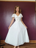 Decorative bust bow, less full skirt, slimmed down 10" butterfly sleeves 