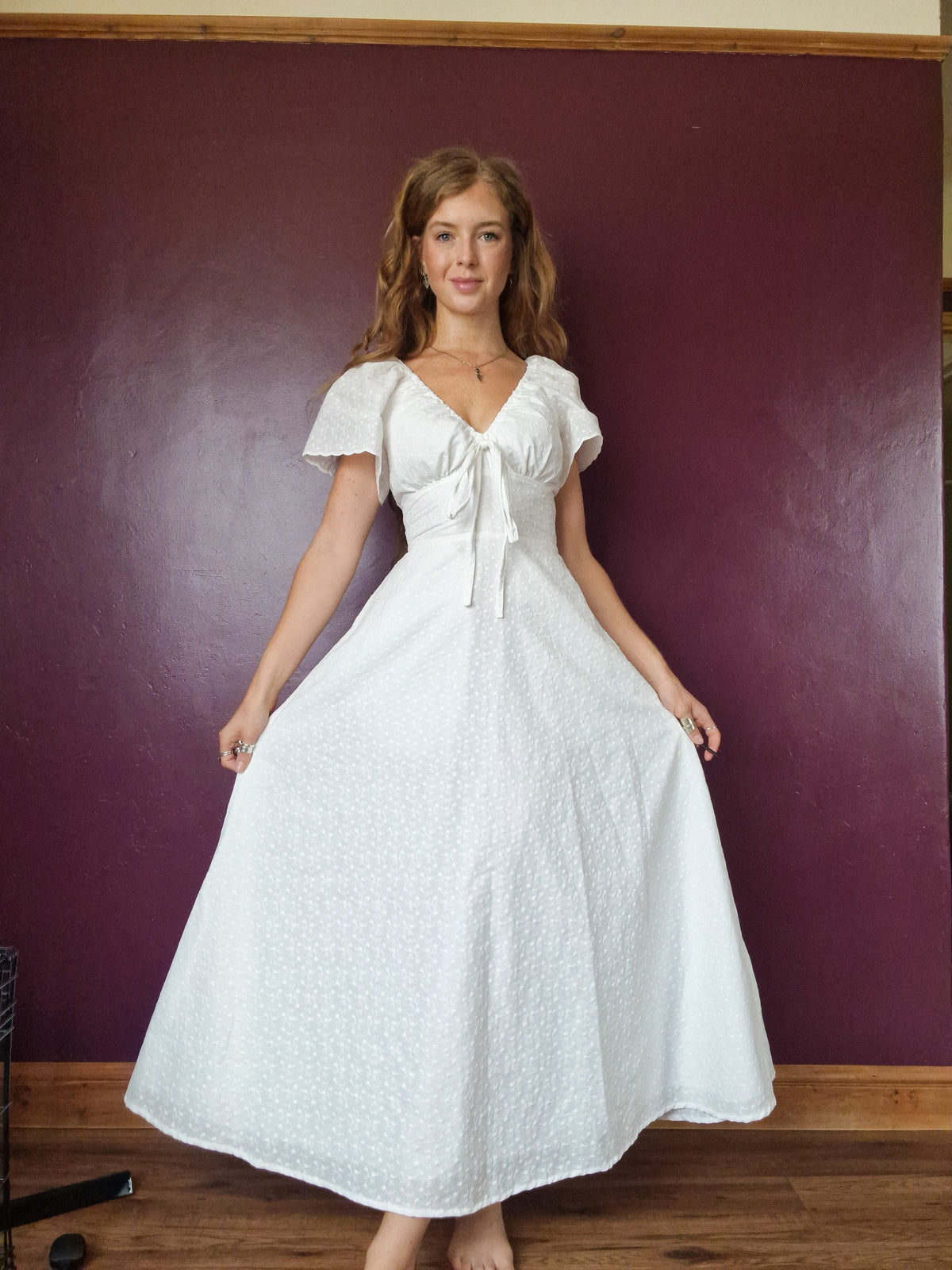 Decorative bust bow, less full skirt, slimmed down 10" butterfly sleeves 